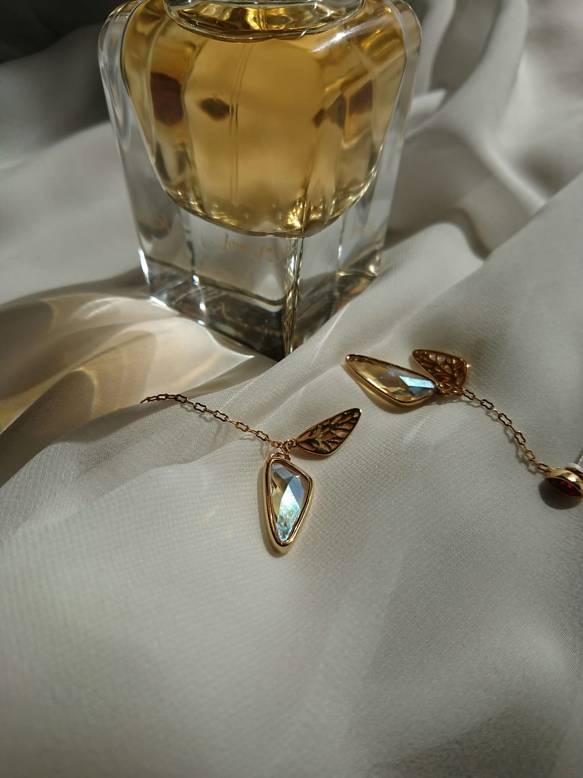 Elegant perfume bottle and gold jewelry